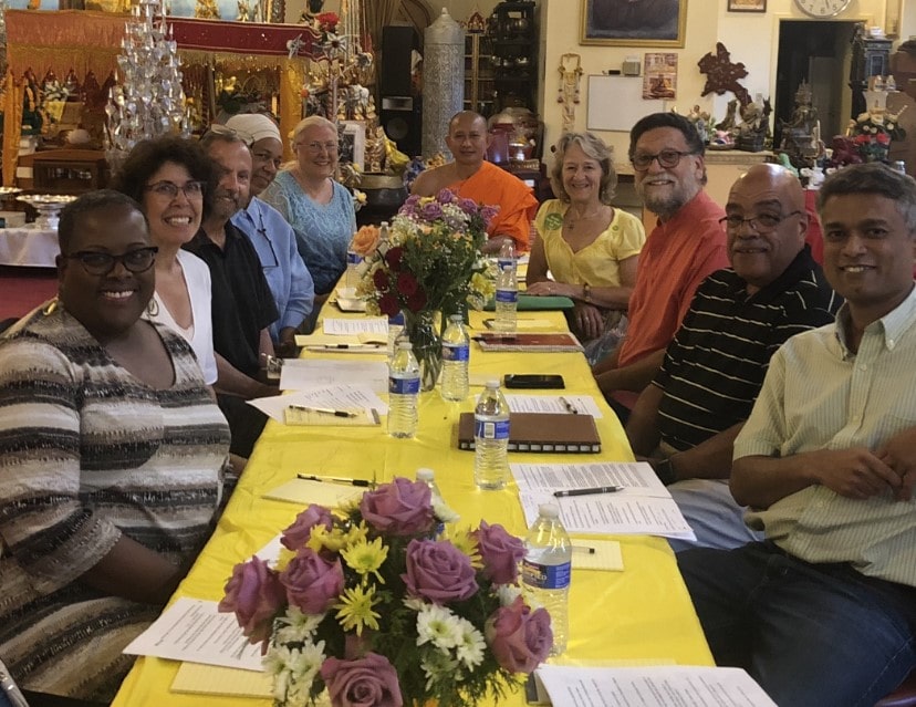 A multi-racial and cultural group having a meeting around a table